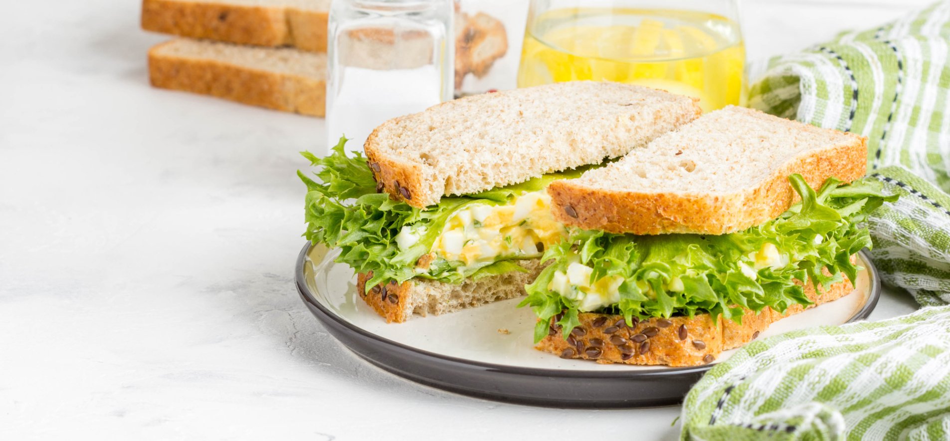 Сэндвич с яйцом и листьями салата.