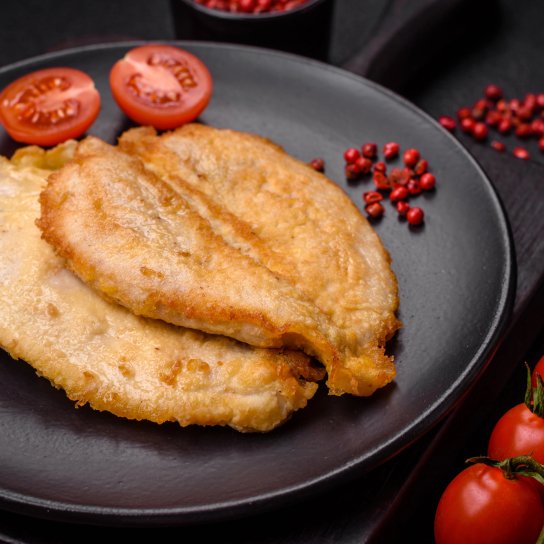 Курячі відбивні в кефірному клярі, запечені в духовці